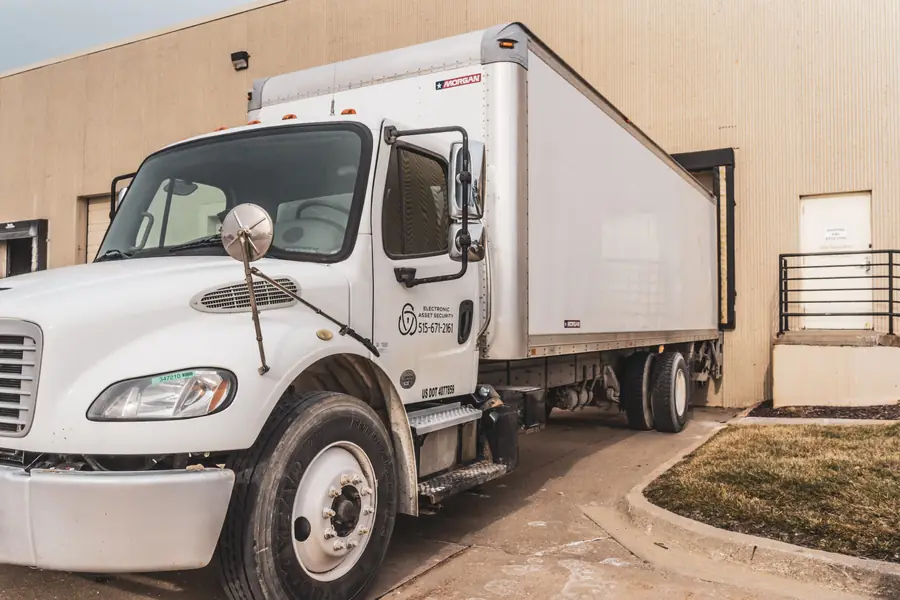 An Electronic Asset Security box truck at a loading dock